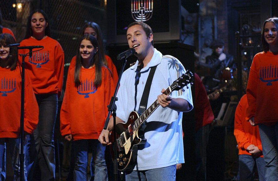 SATURDAY NIGHT LIVE -- Episode 6 -- Aired 11/16/2002 -- Pictured: (center) Adam Sandler during "The Chanukah Song" skit on November 16, 2002 (Photo by Dana Edelson/NBCU Photo Bank/NBCUniversal via Getty Images via Getty Images)