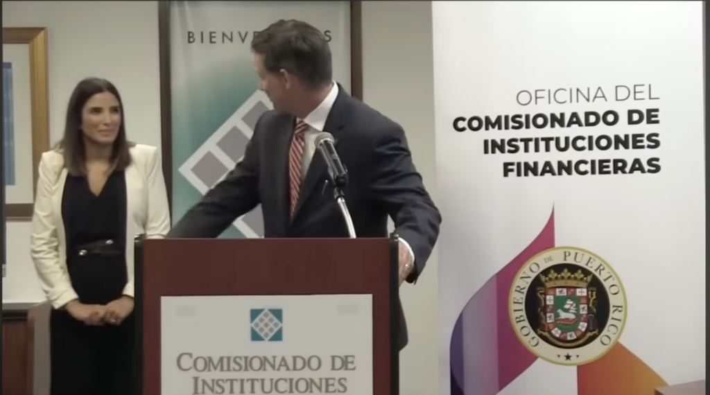 IRS Chief Jim Lee looks to OCIF Commissioner Natalia Zequeira at the June 2022 press conference.