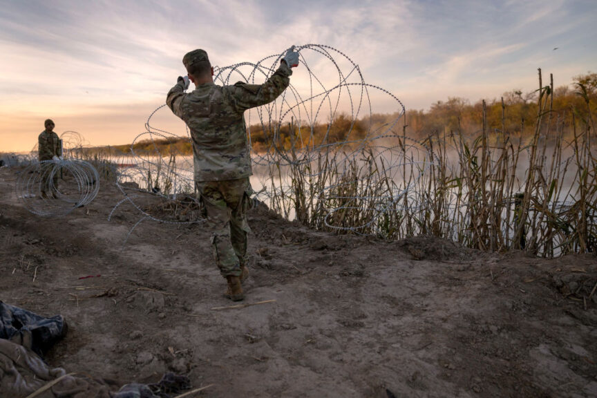 EAGLE PASS, TEXAS - JANUARY 10: Texas National Guard soldiers install additional razor wire lie along the Rio Grande on January 10, 2024 in Eagle Pass, Texas. Following a major surge of migrant border crossings late last year, miles of razor wire as well as huge quantities of refuse remain along the U.S.-Mexico border at Eagle Pass. (Photo by John Moore/Getty Images)