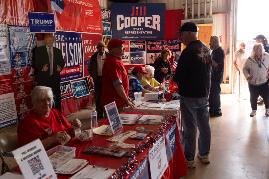 GREENSBURG, PENNSYLVANIA - AUGUST 21: Supporters of former President Donald Trump volunteer at a Republican Party booth at the the Westmoreland Fair, handing out lawn signs and registering voters, August 21, 2024 in rural Westmoreland County, Pennsylvania. Pennsylvania is deeply divided politically, with the urban centers at either end of the state supporting the Democratic Party, and large sections of the rural communities enthusiastic for a second Donald Trump victory.(Photo by Andrew Lichtenstein/Corbis via Getty Images)