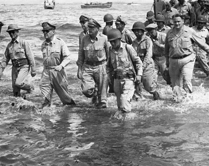 General Douglas MacArthur (second from left) walks to the shore of Leyte Island with a group of U.S. Army and Philippine officers