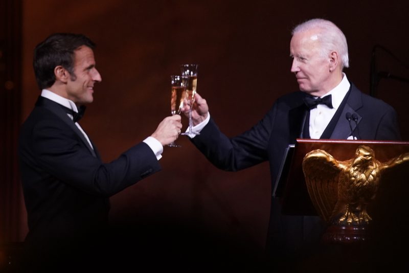 President Joe Biden and French President Emmanuel Macron toast during a State Dinner on the South Lawn of the White House in Washington, Thursday, Dec. 1, 2022. (AP Photo/Andrew Harnik)