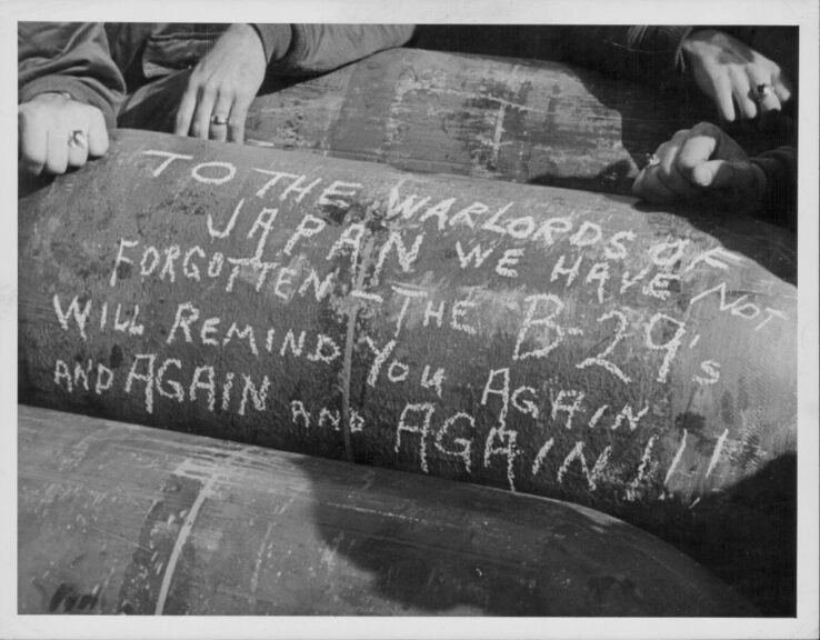 US Marines write a message on the side of a bomb; 'To the warlords of Japan, we have not forgotten - the B-29's will remind you again and again and again', during the Pacific Campaign of World War Two, Saipan, circa 1939-1945. (Photo by European/FPG/Getty Images)