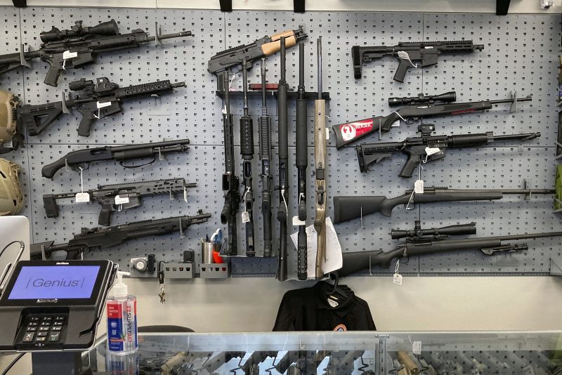 FILE - Firearms are displayed at a gun shop in Salem, Ore., on Feb. 19, 2021. A federal judge in Portland, Ore., ruled Tuesday, Dec. 6, 2022, that a new voter-passed ban on high-capacity gun magazines can go into effect Thursday, Dec. 8, but placed a 30-day hold on a permit-to-purchase requirement after local and state law enforcement agencies said they could not have a permitting system ready in time. (AP Photo/Andrew Selsky, File)