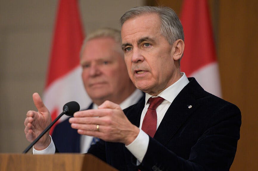 Mark Carney, Canada's prime minister, and Doug Ford, Ontario's premier, left, during a news conference in Ottawa, Ontario, Canada, on Thursday, Dec. 18, 2025. Carney's government signed a deal with Ontario to remove duplication in environmental assessments as Canada pushes to develop resources and build projects more quickly. Photographer: James Park/Bloomberg via Getty Images