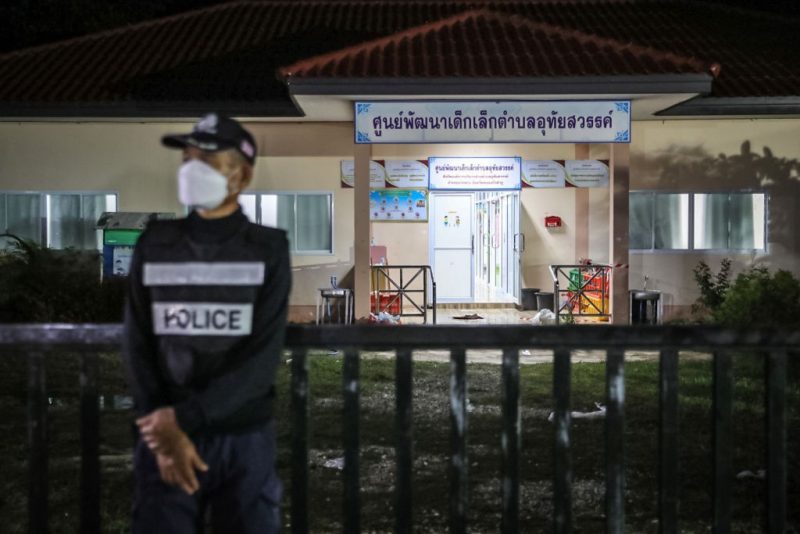 A policeman standing watch outside a day care center in Thailand following a mass shooting. LAUREN DECICCA / GETTY IMAGES