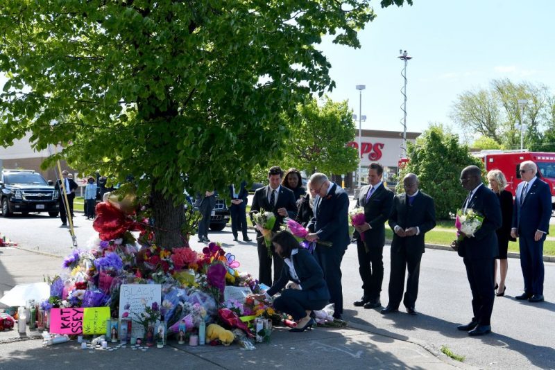 US President Joe Biden (R) and US First Lady Jill Biden (2R) look on as New York State Governor Kathy Hochul and US Senate Majority Leader Chuck Schumer (D-NY) read a note at a memorial near a Tops grocery store in Buffalo, New York, on May 17, 2022. - Biden is visiting Buffalo after ten people were killed in a mass shooting at a grocery store on May 14, 2022. (Photo by Nicholas Kamm / AFP) (Photo by NICHOLAS KAMM/AFP via Getty Images)