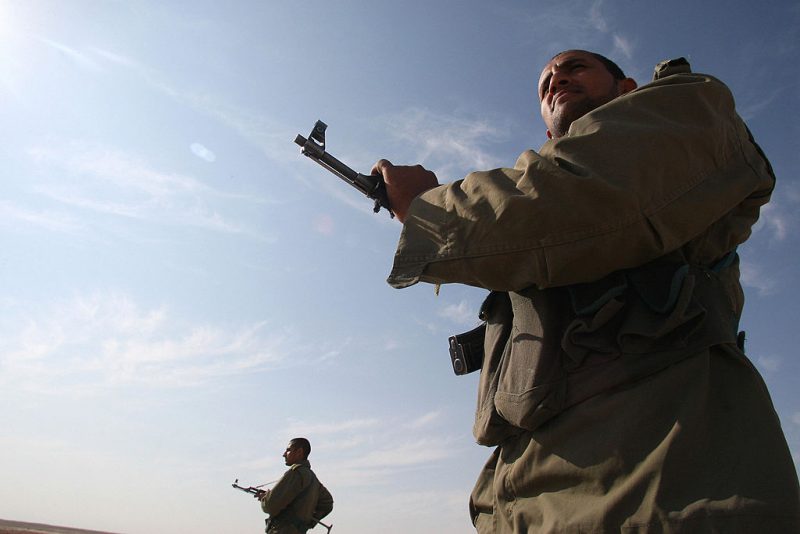 ranian soldiers stand guard on a mound built to prevent drug trafficking in the southeastern town of Zabol on November 29, 2008. The town is near Iran's border with Afghanistan and Pakistan, and sits on a major trafficking route. Drug trafficking is punishable by death under the Sharia-based law practised in Iran following the 1979 Islamic revoluion. AFP PHOTO/ATTA KENARE (Photo credit should read ATTA KENARE/AFP via Getty Images)